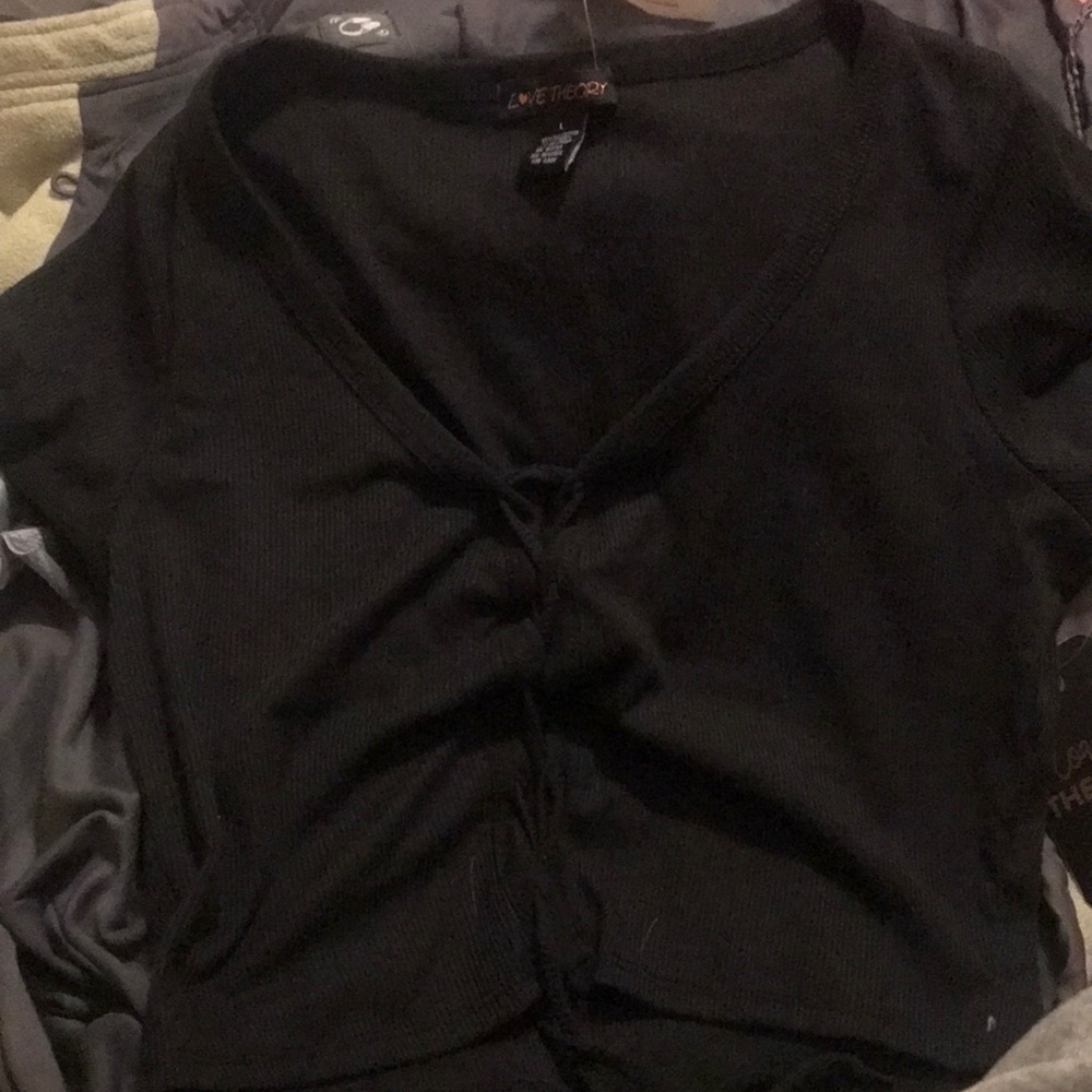 A black crop top , The size is a large , it has never been worn before it’s new.